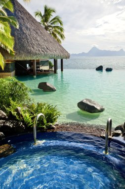 Jacuzzi and infinity pool over tropical ocean clipart