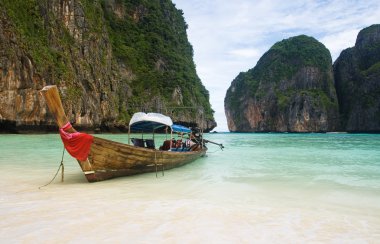 Fishing boat on Thailand beach clipart