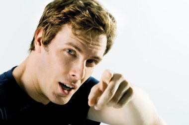 Young man with a serious look, pointing his finger outwards towards you clipart