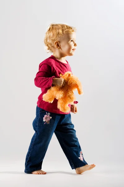 Menina Feliz Andando Com Brinquedo Estúdio — Fotografia de Stock