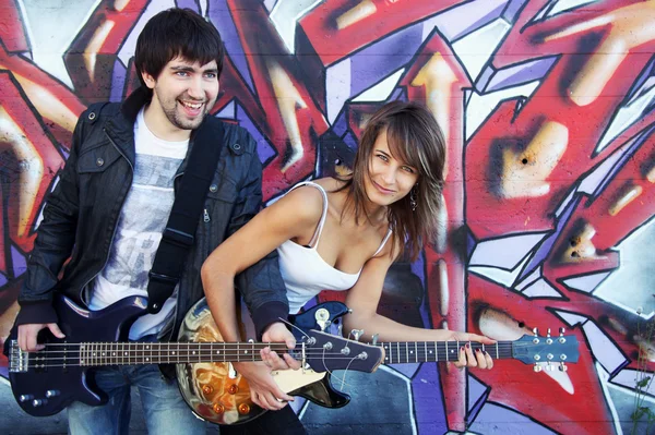 Young couple play on guitars — Stock Photo, Image