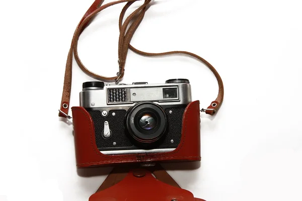 Φωτογραφική μηχανή ταινία κινηματογραφήσεων σε πρώτο πλάνο σε μια περίπτωση δέρματος που απομονώνονται σε λευκό — Φωτογραφία Αρχείου
