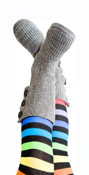 Stripy legs - female legs in brightly colored stockings and knit — Stock Photo, Image