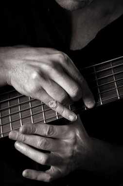 G major chord on six-string electric bass guitar (right hand tapping technique); toned monochrome image; clipart