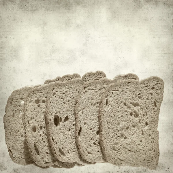 Texturizado fundo de papel velho com pão marrom fatiado — Fotografia de Stock