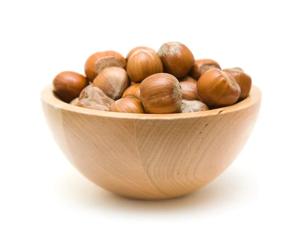 Hazelnuts in small wooden bowl isolated on white backgound; — Stock Photo, Image