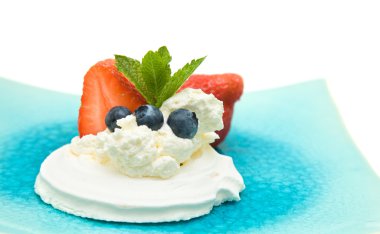 Meringue nest with whipped cream and fresh berries, decorated with mint, isolated on white, clipart