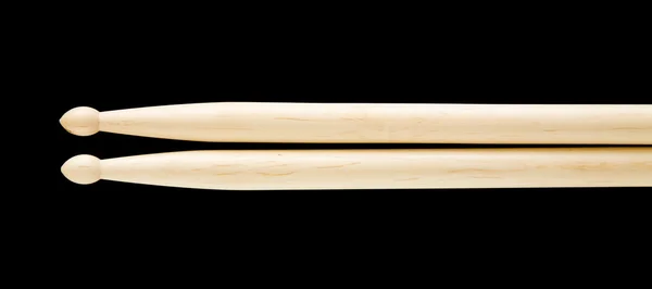 Pair of simple wooden drumsticks isolated on black background — Stock Photo, Image