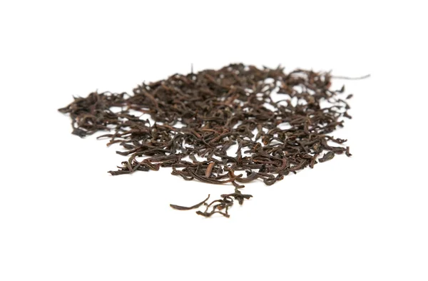 Scattered dry black tea leaves on white background; — Stock Photo, Image