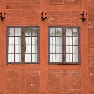 Two old multipanel windows in a terracotta colored brick and wood wall, house, building, old-fashioned, architectural, detail, two, curtained clipart