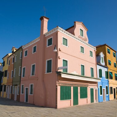 Burano island in lagoon of Venice; brightly-colored house; washing clipart