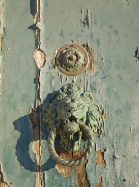 Murano, derocative loop/knocker on an old wooden door clipart