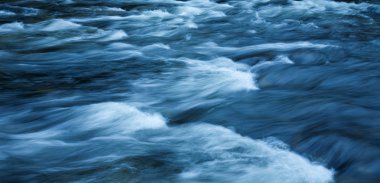 Fast-flowing water background, long exposure clipart