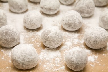 Tray of chocolate dough balls with icing sugar dusting (making cookies) ab clipart