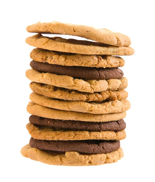 Alta pilha de diferentes tipos de cookies, isolados em wh — Fotografia de Stock