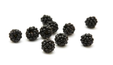 Handful of ripe scattered blackberries isolated on white backgro clipart