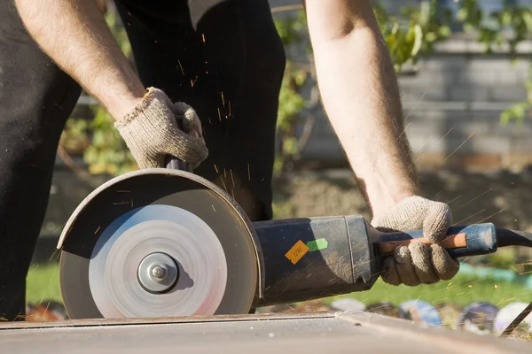 Closeup worker with angle grinder — Stock Photo, Image