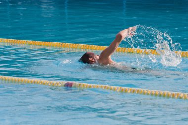 Man swimming in pool. Swim training clipart