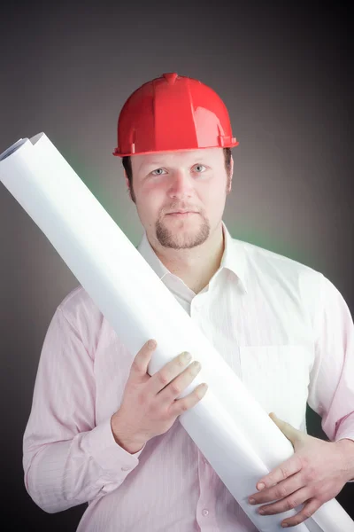 Young attractive engineer with blueprints — Stock Photo, Image