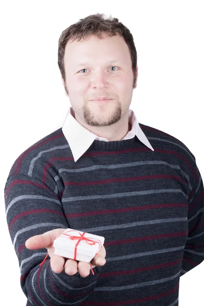 Young man holding valentine gift in his hand. He is giving it so — Stock Photo, Image