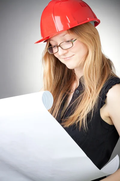 Young Woman Helmet Blueprint Grey Background — Stock Photo, Image