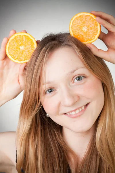 Beautiful young woman has orange ears — Stock Photo, Image