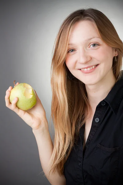 Beautiful blond girl eating apple — Stock Photo, Image