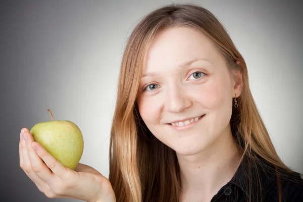 Beautiful blond girl holding an apple — Stock Photo, Image