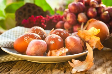 Naturally colored Easter eggs with onion skin and hand-painted clipart