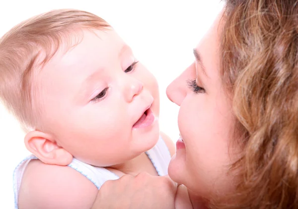 Happy young mother kissing a baby — Stock Photo, Image
