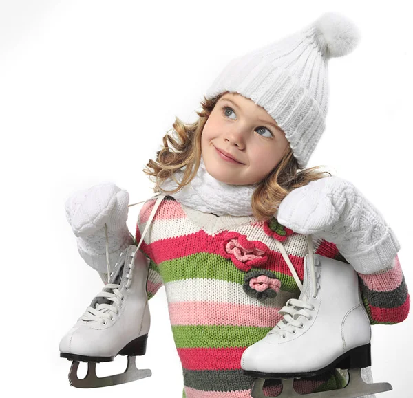Fille en vêtements d'hiver avec patins artistiques Image En Vente