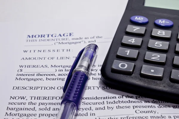 stock image Agreement form mortgage calculator and pen