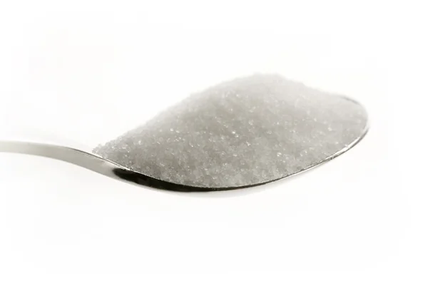 Сахар на ложке — стоковое фото