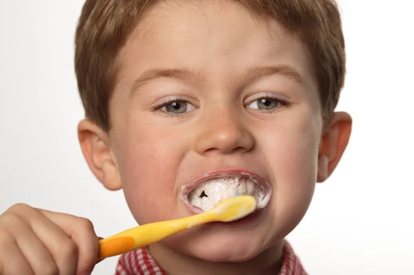 stock image Cute young boy brushing teeth with positive expression