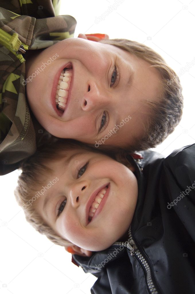 Two cute young boys with a teethy smile