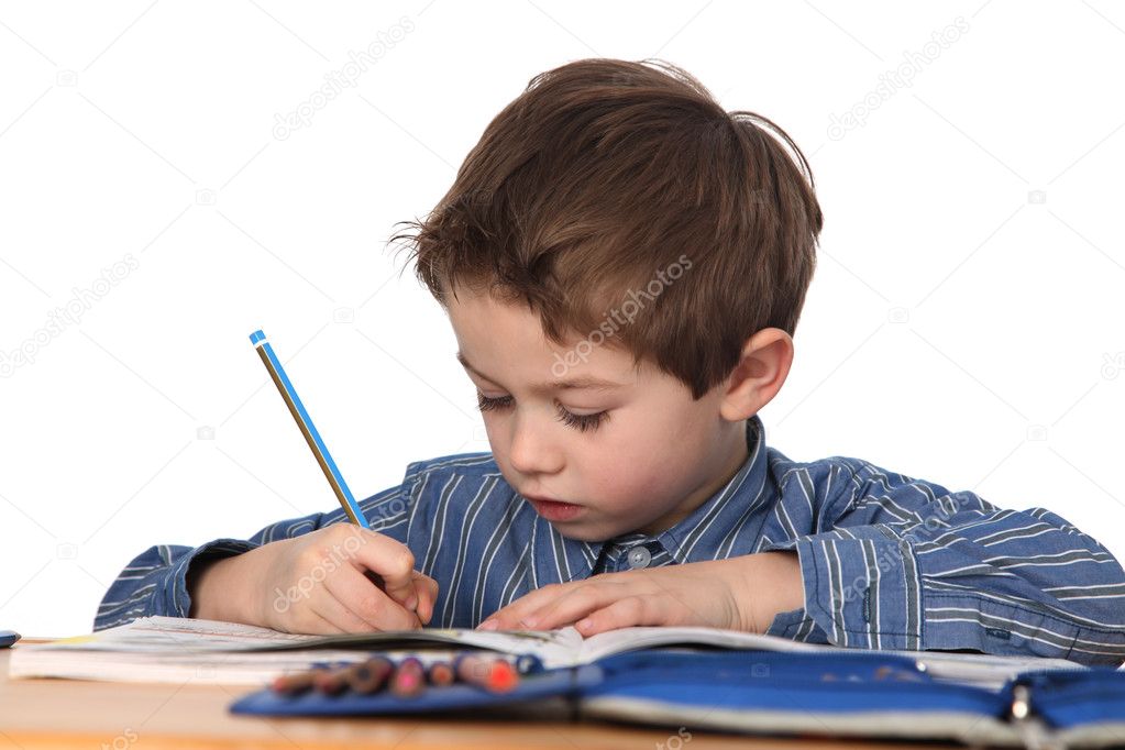 Cute young boy doing homework