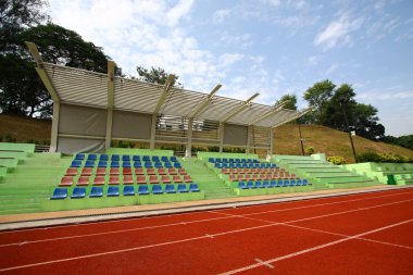 Stadium with running tracks and chairs clipart