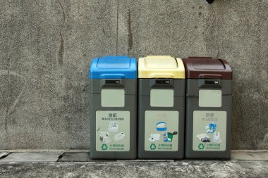 Recycling bins. Three different colors imply different usage. clipart