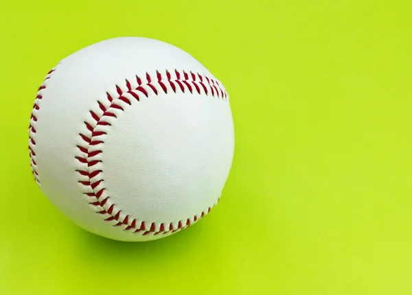 stock image Isolated baseball on a bright green background