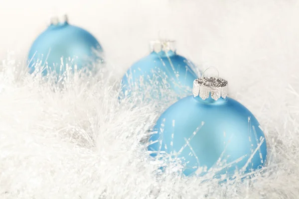 stock image Three powder blue Christmas decorations on a white garland.