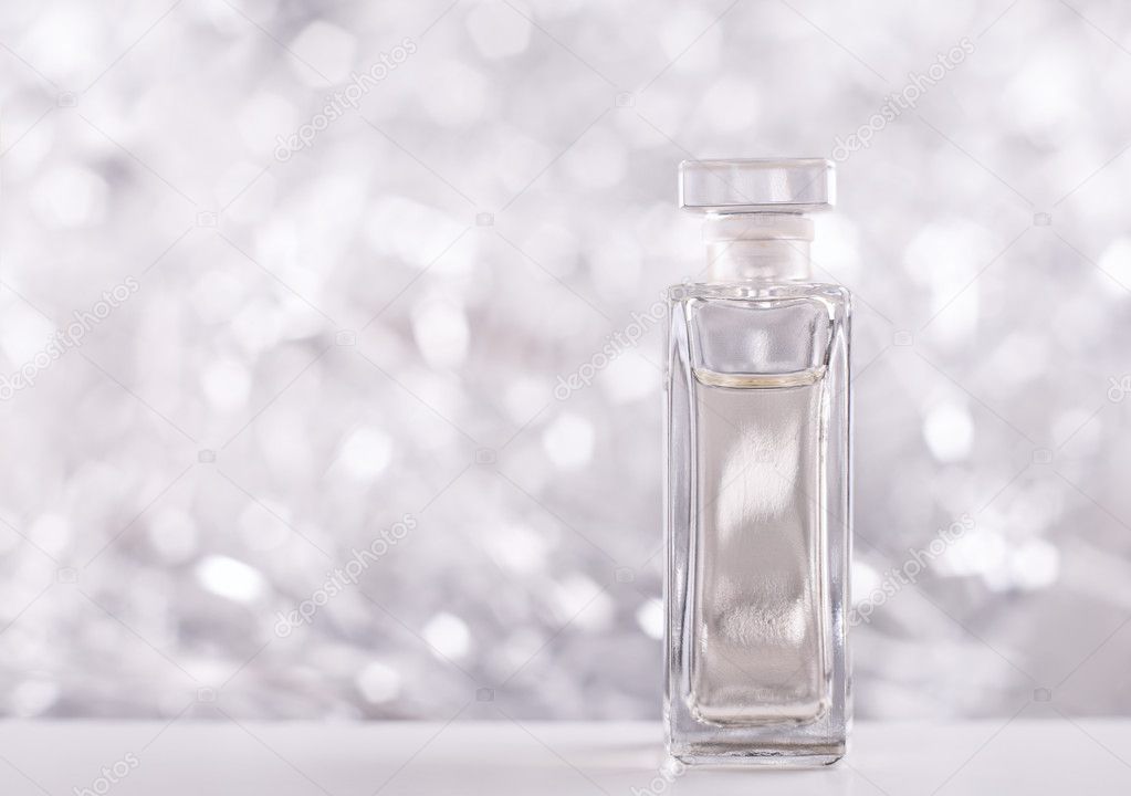A bottle of Perfume on sparkling background.