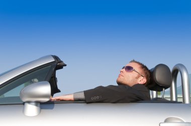 Man relaxing in his car clipart