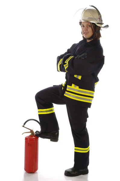 Junge Feuerwehrfrau in Uniform mit Feuerlöscher — Stock Fotó