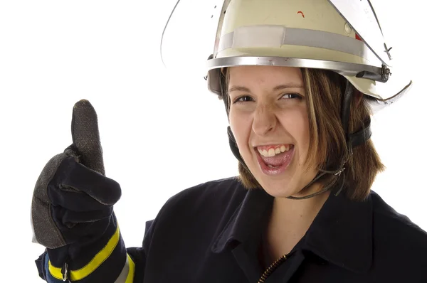 Junge Feuerwehrfrau in uniforme macht Daumen hoch Geste — Foto Stock