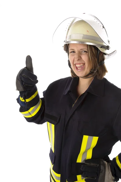 Junge Feuerwehrfrau em uniforme macht Daumen hoch Geste — Fotografia de Stock