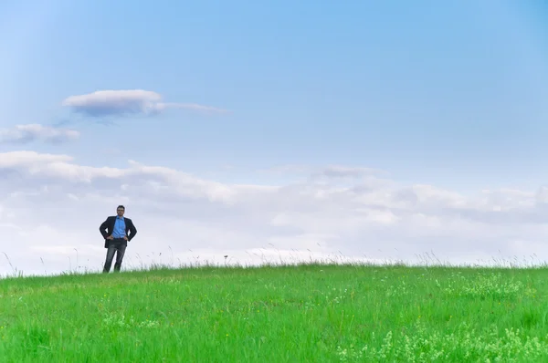 Businessman Suit Standing Meadow Looks Distance Front Clouds — Stock Photo, Image