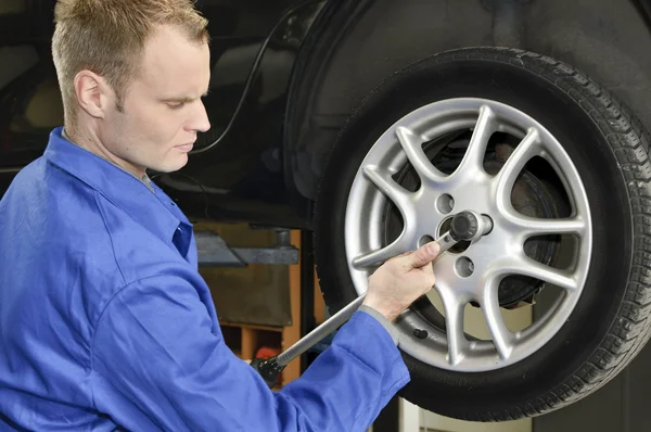 Changing wheels in car workshop Stock Picture