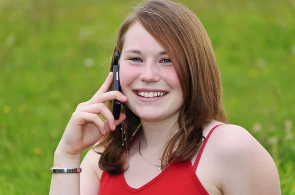 Cute girl outdoors with telephone — Stock Photo, Image