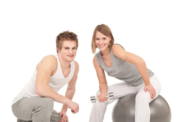 Γυμναστήριο - νεαρό ζευγάρι προπόνηση με βάρη και μπάλα — Φωτογραφία Αρχείου