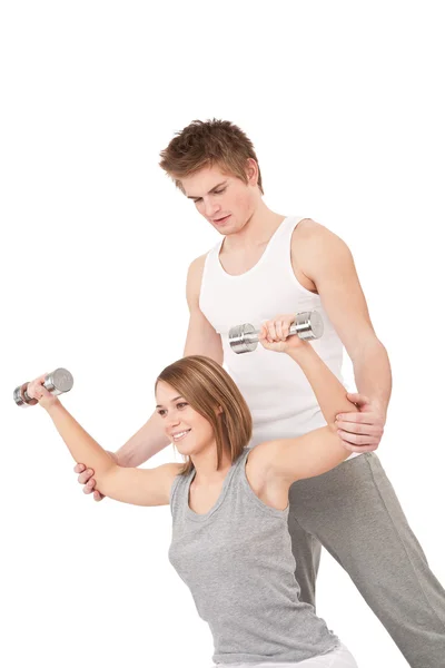 Fitness - Young woman with instructor lifting weights — Stock Photo, Image